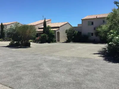 an empty parking lot in front of a building at Charming rental with shared-pool in the Alpilles. in Mouriès