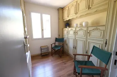a living room with two chairs and a window at Very pleasant vacation rental with heated pool in the Luberon in Gargas