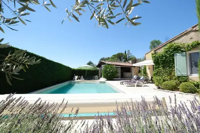 a swimming pool in a yard with a house at Very pleasant vacation rental with heated pool in the Luberon in Gargas