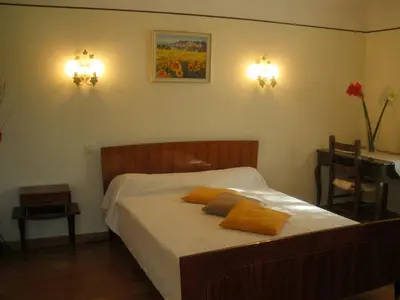 a bedroom with a bed with two pillows on it at Spacious villa on two levels in Cabrières-dʼAvignon