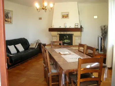 a living room with a table and a fireplace at Spacious villa on two levels in Cabrières-dʼAvignon