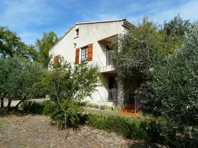 an old house with trees in front of it at Spacious villa on two levels in Cabrières-dʼAvignon