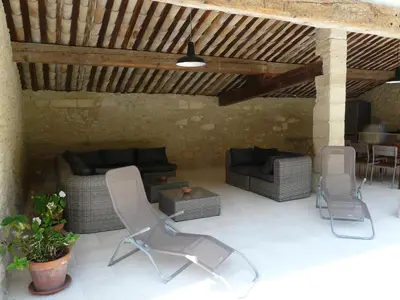 a patio with chairs and a couch and a table at 19th century Provencal Mas with pool in Provence in the Luberon, sleeps 6 in Lacoste