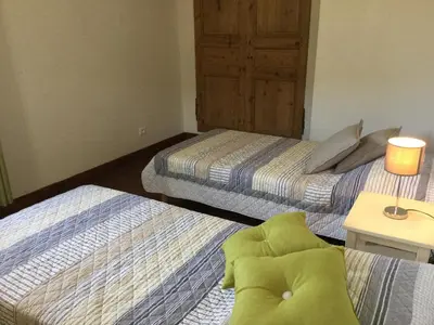 a bedroom with two beds and a table with a lamp at 19th century Provencal Mas with pool in Provence in the Luberon, sleeps 6 in Lacoste