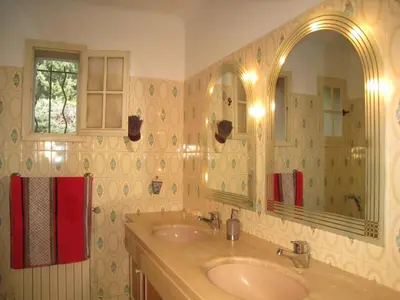 a bathroom with two sinks and a mirror at vacation home with private swimming-pool and a nice view on the luberon mountain, located in merindol, 8 persons in Mérindol
