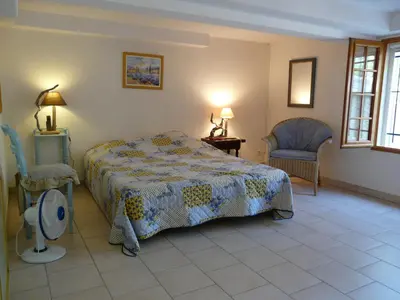 a bedroom with a bed and two chairs at vacation home with private swimming-pool and a nice view on the luberon mountain, located in merindol, 8 persons in Mérindol