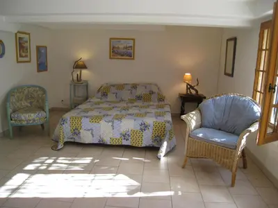a bedroom with a bed and a chair at vacation home with private swimming-pool and a nice view on the luberon mountain, located in merindol, 8 persons in Mérindol