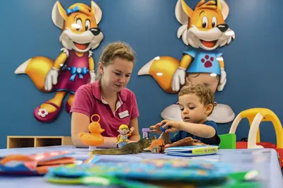 a woman and a child playing with toys at a table at Belambra Clubs L'Isle Sur La Sorgue - Domaine De Mousquety in LʼIsle-sur-la-Sorgue