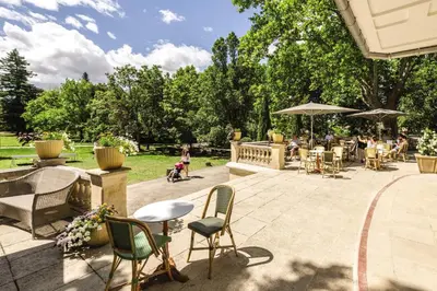 a patio with chairs and tables in a park at Belambra Clubs L'Isle Sur La Sorgue - Domaine De Mousquety in LʼIsle-sur-la-Sorgue
