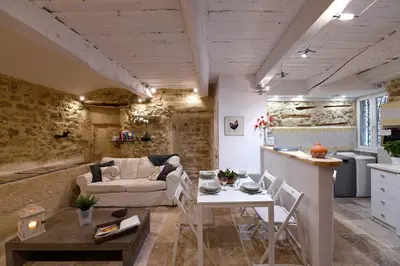 a living room with a couch and a table at Le petit trésor du Luberon in Ménerbes
