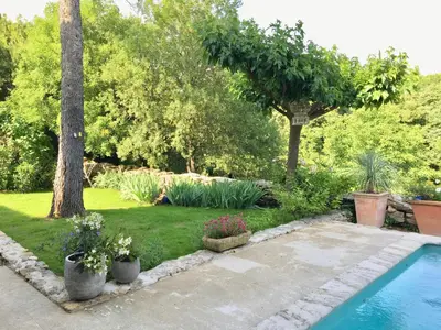 a garden with a swimming pool and trees and plants at Belle De Jour -A Provencal gem Private heated pool in Gordes