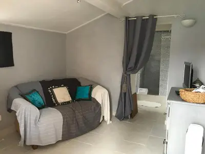 a living room with a couch and a window at Chambre d'hôtes Le Cèdre in Apt