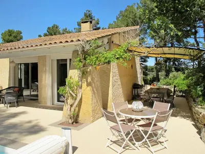 a patio with a table and chairs in front of a house at Holiday Home Luberon Vidauque by Interhome in Cavaillon