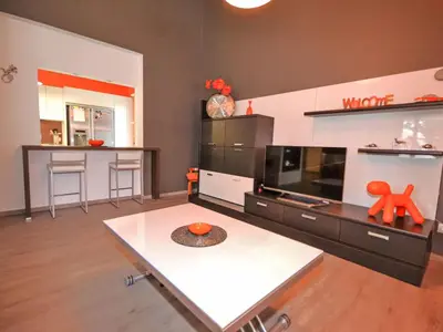 a living room with a table and a tv at Holiday Home Luberon Vidauque by Interhome in Cavaillon