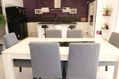 a kitchen with a white table and chairs at very pretty contemporary villa with pool located in Aureille in the alpilles, close to the center on foot. sleeps 4. in Aureille