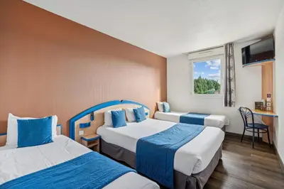 a hotel room with two beds and a window at Hôtel AKENA Chateaurenard - Parc des Expositions Avignon in Châteaurenard