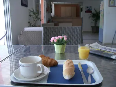 a tray with a cup of coffee and croissants on a table at Hôtel AKENA Chateaurenard - Parc des Expositions Avignon in Châteaurenard