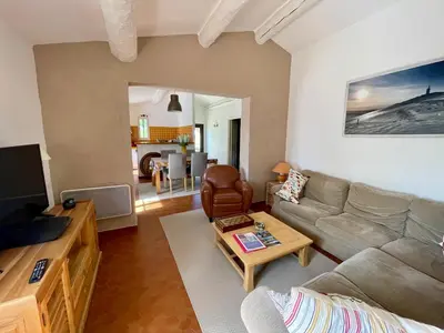a living room with a couch and a table at La belle histoire gîte Luberon in Bédoin