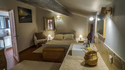 a small room with a bed and a sink in it at La belle histoire gîte Luberon in Bédoin