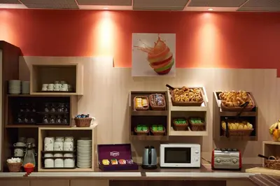 a kitchen with a counter with food on it at Ace Hôtel Salon de Provence in Salon-de-Provence