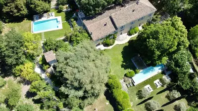 an overhead view of a house with a swimming pool and trees at Bastide de Ganay - Saint Jérôme in Aix-en-Provence