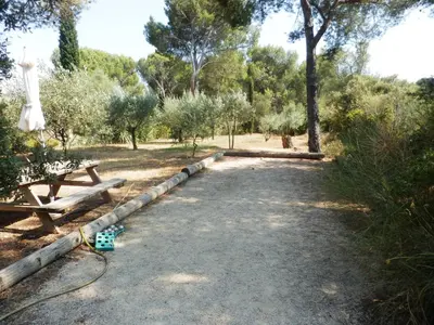 a path in a park with a picnic table and trees at Gite Le city en Provence in Lambesc