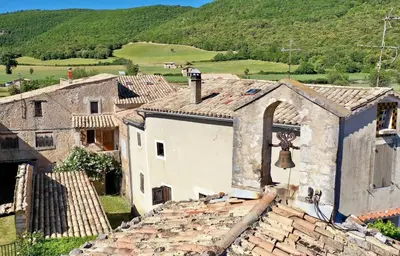 an old building with a bell on top of it at Mas La Miellerie - Charme Authentique et Nature in Simiane-la-Rotonde
