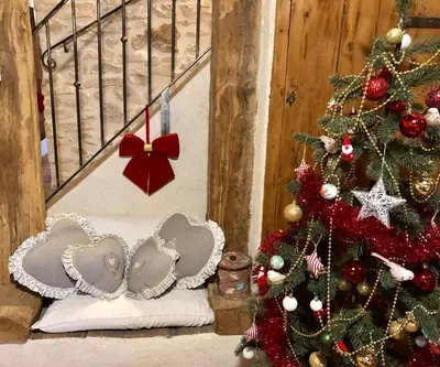 a christmas tree and a pillow next to a staircase at Mas La Miellerie - Charme Authentique et Nature in Simiane-la-Rotonde
