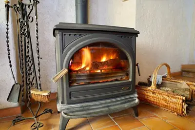 a stove with a fire in a room at Mas La Miellerie - Charme Authentique et Nature in Simiane-la-Rotonde