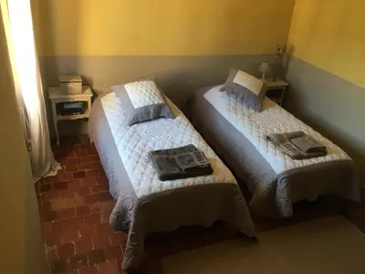 a bedroom with two beds with towels on them at 40 Rue du Ventoux in Bédoin