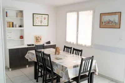 a dining room with a table and chairs at Gites Velaux Ecureuil et Pinède in Velaux