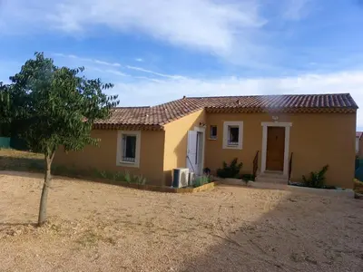 a small yellow house with a tree in front of it at Villa confortable avec piscine privée à Saint-Saturnin-lès-Apt in Croagnes