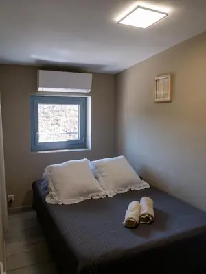 a bedroom with a bed with two shoes on it at Location Bonnieux Provence in Bonnieux