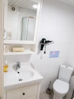 a bathroom with a sink and a toilet and a mirror at Location Bonnieux Provence in Bonnieux