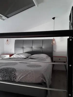 a bedroom with a bed with a metal frame at Yofanto in Sénas
