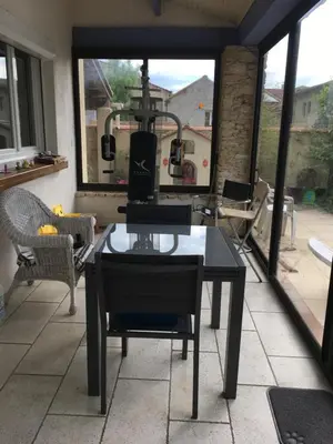 a screened in porch with a table and chairs at Maison de village in Velleron