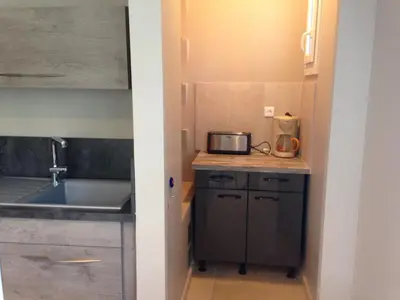 a small kitchen with a sink and a microwave at La roseraie Bonnieux in Bonnieux