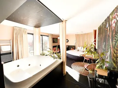 a large bathroom with a tub and a living room at Maison Florence Ivakno in Coudoux
