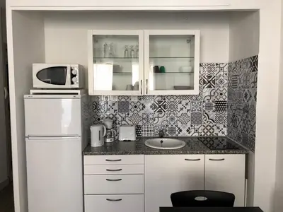 a kitchen with a sink and a microwave at Aix Homes in Aix-en-Provence