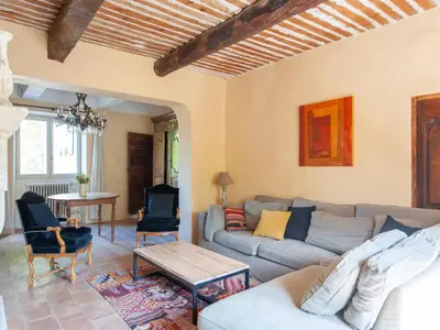 a living room with a couch and a table at Villa in Saignon with Pool and Scenic Views in Ménerbes