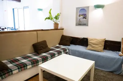 a living room with a couch and a bed at Le palais, hôtel - restaurant in Apt