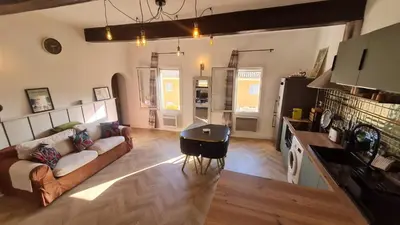 a living room with a couch and a table at Sunny Apartment with Nice View in History City Center in Aix-en-Provence