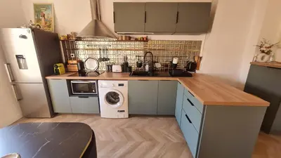 a kitchen with a refrigerator and a washing machine at Sunny Apartment with Nice View in History City Center in Aix-en-Provence