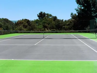 a tennis court with a net on top of it at Villa in Saumane near Golf Course and Pool in Saumane-de-Vaucluse