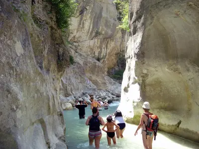 a group of people walking in the water in a canyon at Villa in Saumane near Golf Course and Pool in Saumane-de-Vaucluse