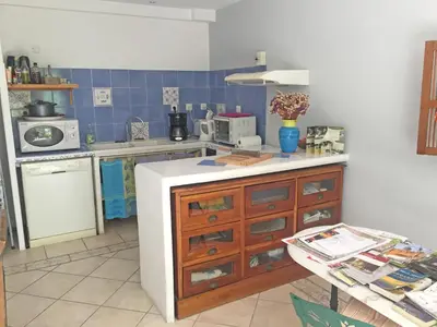a kitchen with a white counter top and a stove at Les Restanques in Goult