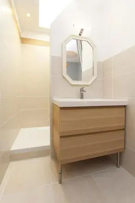 a bathroom with a sink and a tub and a mirror at 