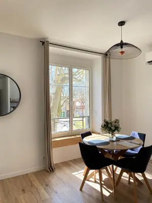 a dining room with a table and chairs and a window at 