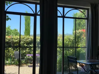 a view from a window looking out onto a garden at Domaine La Condamine CRILLON LE BRAVE in Crillon-le-Brave