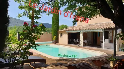 a swimming pool in front of a house at Le Jardin d'Ivana in Oppède